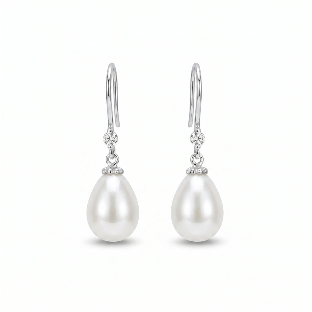 Woman wearing 925 sterling silver freshwater pearl drop earrings with sparkling zirconia accents, elegant bridal jewellery for weddings and special occasions