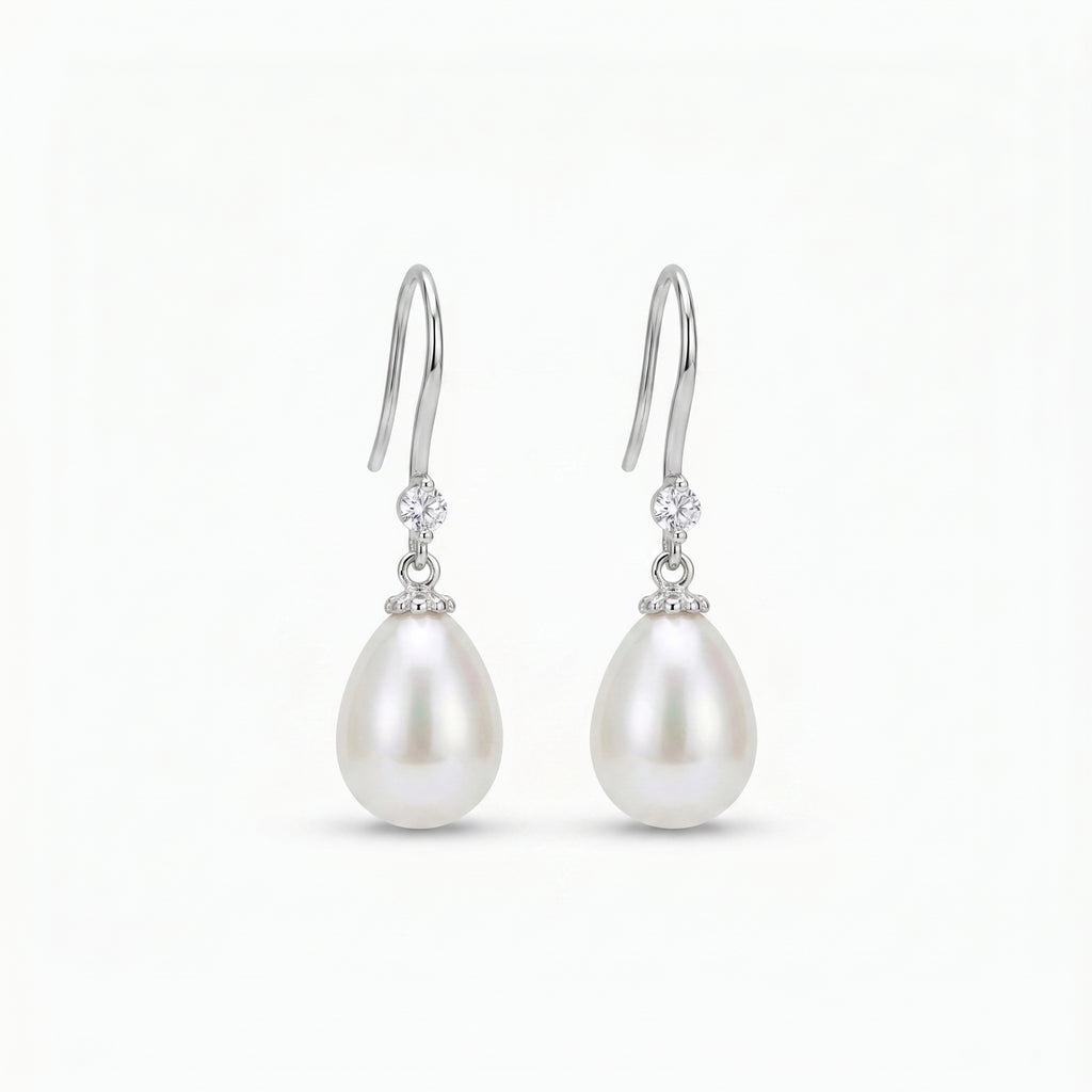 Close-up of 925 sterling silver pearl drop earrings featuring natural freshwater pearls and zirconia stones, worn by a bride